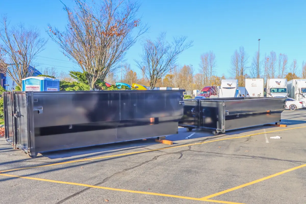 Professional dumpster rental service with roll-off container on residential driveway in Iron Mountain